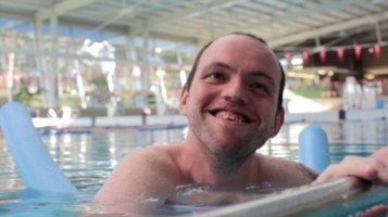 man in pool smiling