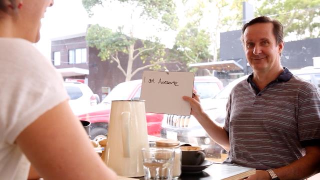 Man holding sign up saying 'I am awesome'